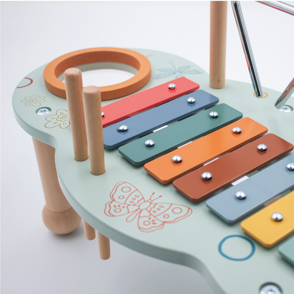 Close up of wooden xylophone on baby music table showing colourful keys